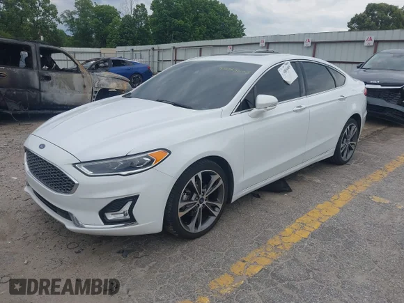 ✅ 2020 Ford Fusion Titanium • VIN: 3FA6P0D95LR132969 • Лот: 45083605. Опубліковано раніше на IAAI з пробігом 144 227 миль. Безкоштовний доступ до архіву аукціонних продажів зі США та докладний звіт про історію автомобіля на DreamBid. Зображення 2.