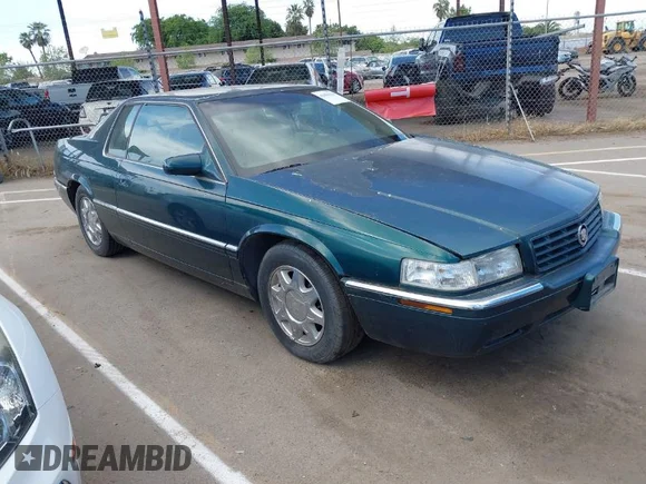 ✅ 1998 Cadillac Eldorado Touring • VIN: 1G6ET1290WU606076 • Лот: 42004118. Опубликован ранее на IAAI с пробегом 103 860 миль. Бесплатный доступ к архиву аукционных продаж из США и подробный отчёт об истории автомобиля на DreamBid. Изображение 1.