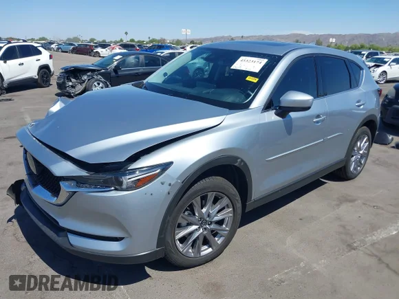 ✅ 2021 Mazda CX-5 Grand Touring Reserve • VIN: JM3KFBAY5M0381770 • Лот: 45323174. Опубликован ранее на IAAI с пробегом 23 434 миль. Бесплатный доступ к архиву аукционных продаж из США и подробный отчёт об истории автомобиля на DreamBid. Изображение 2.