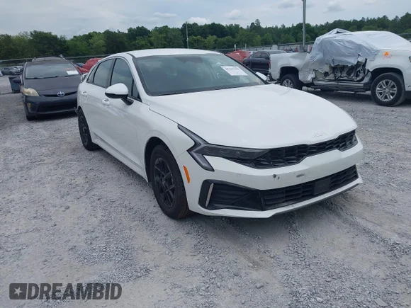 ✅ 2026 Kia K5 LXS • VIN: KNAG24J77T5444217 • Лот: 45327799. Опубликован ранее на IAAI с пробегом 12 235 миль. Бесплатный доступ к архиву аукционных продаж из США и подробный отчёт об истории автомобиля на DreamBid. Изображение 1.